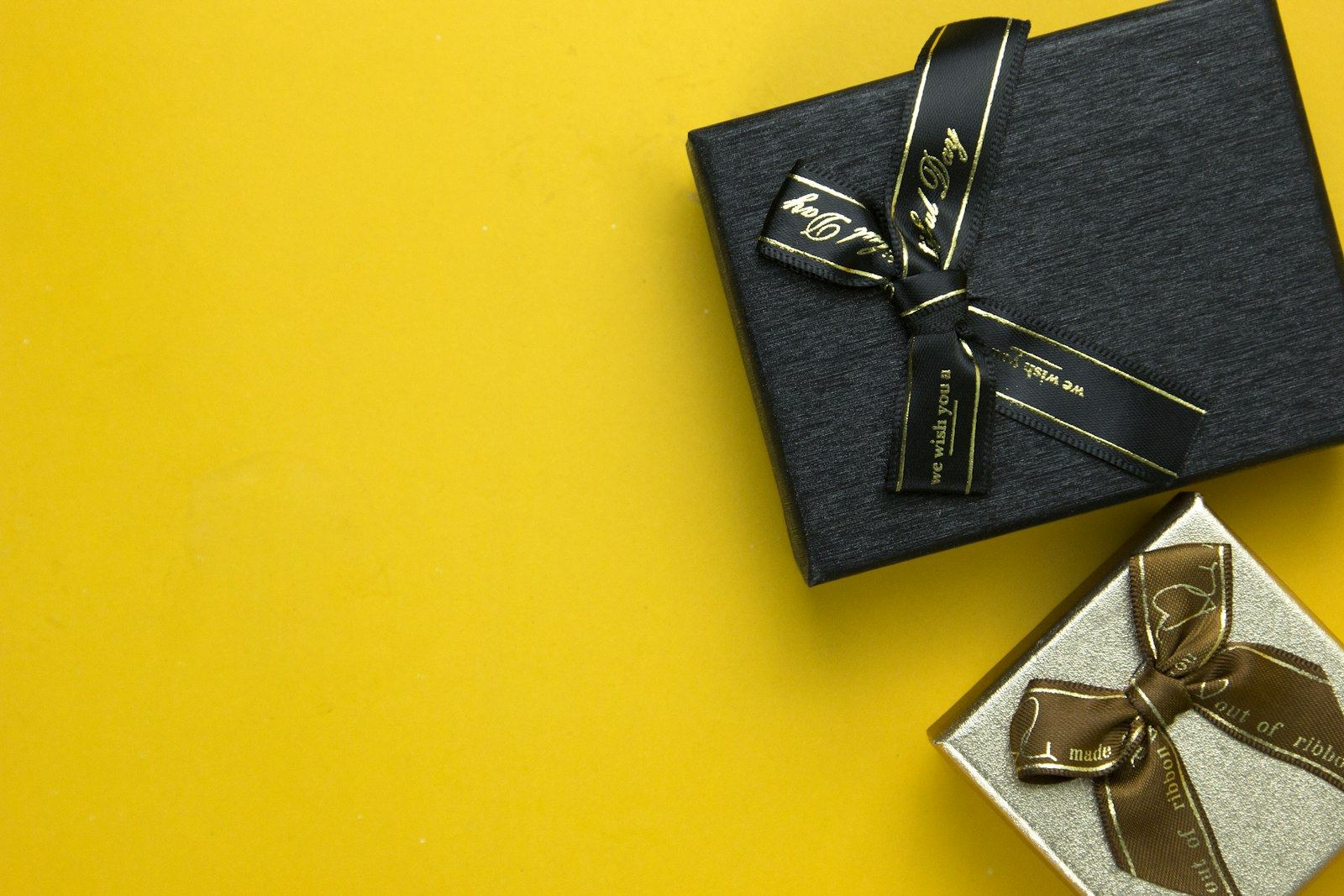 A black gift box tied with a gold ribbon
